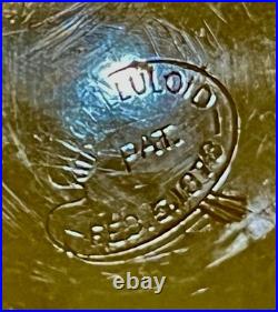 An antique carved celluloid powder box