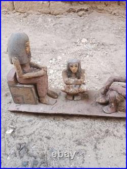 Ancient egyptian antique wooden figurine group depicting daily life social scene
