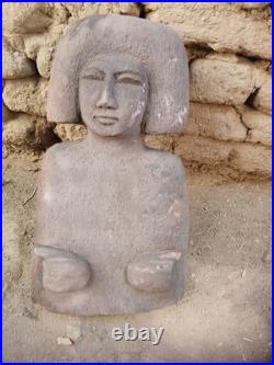 Ancient egyptian antique wooden sculpture with distinctive hair, primitive style