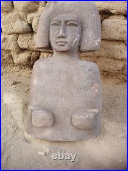 Ancient egyptian antique wooden sculpture with distinctive hair, primitive style