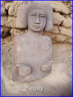 Ancient egyptian antique wooden sculpture with distinctive hair, primitive style