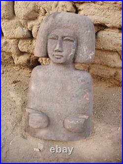 Ancient egyptian antique wooden sculpture with distinctive hair, primitive style