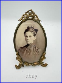 Antique oval picture frame ornate brass scrolling top ribbon accent