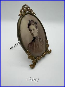 Antique oval picture frame ornate brass scrolling top ribbon accent