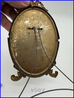 Antique oval picture frame ornate brass scrolling top ribbon accent