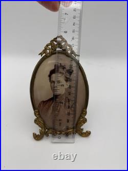 Antique oval picture frame ornate brass scrolling top ribbon accent