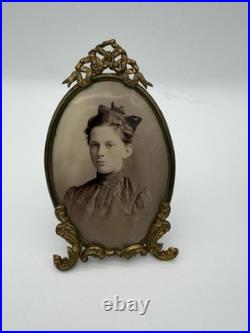 Antique oval picture frame ornate brass scrolling top ribbon accent