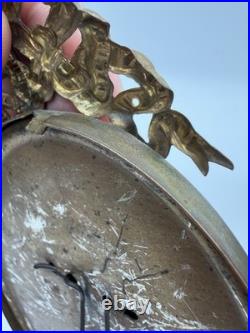 Antique oval picture frame ornate brass scrolling top ribbon accent