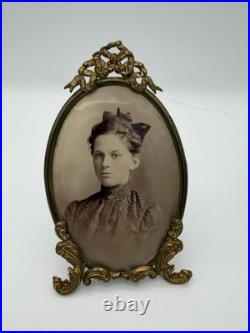 Antique oval picture frame ornate brass scrolling top ribbon accent