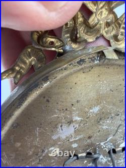 Antique oval picture frame ornate brass scrolling top ribbon accent