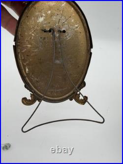 Antique oval picture frame ornate brass scrolling top ribbon accent