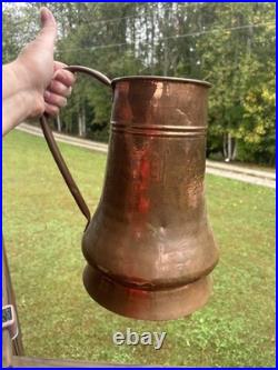Vintage or antique hand-hammered copper jug or pitcher